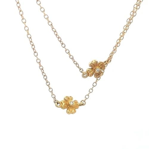 DIAMOND GOLD NECKLACE 18K YELLOW FLORAL MOTIF LONG CHAIN FLEUR DE LIS 32" LONG: This elegant long chain necklace is crafted from 18k yellow gold, it has small flower motifs, each with 4 petals and a small bezel set diamond in the center of the flower on both sides. On each end of