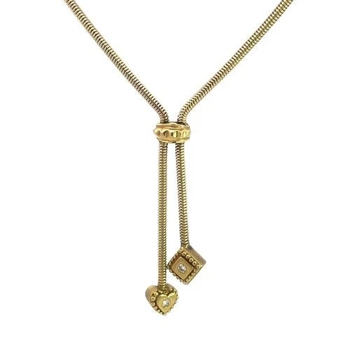 DIAMOND GOLD BOLO STYLE NECKLACE VINTAGE 14K YELLOW ROUND SNAKE CHAIN LARIAT: This diamond and gold necklace is a vintage piece made of 14k yellow gold with natural round white diamond accent, one each set in a heart and square shaped dangle pendant. The necklace features a tig
