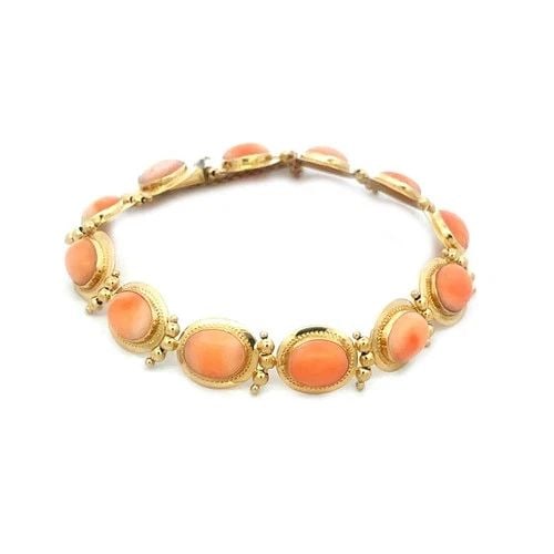 CORAL GOLD BRACELET 18K YELLOW CABOCHON OVAL SET ANGEL SKIN: CORAL GOLD BRACELET 18K YELLOW CABOCHON OVAL SET ANGEL SKIN The Coral Gold Bracelet is a vintage piece of fine jewelry crafted from 18k yellow gold. The bracelet features beautiful oval cabochon peach