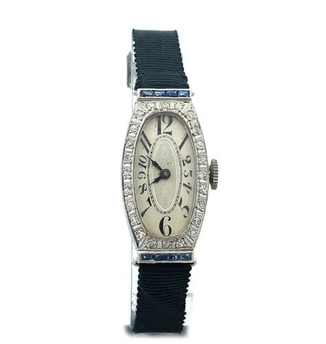 ART DECO DIAMOND PLATINUM HAND WIND ELONGATED LADIES WRISTWATCH: ART DECO DIAMOND PLATINUM HAND WIND ELONGATED LADIES WRISTWATCH This is a beautiful Art Deco platinum hand wind ladies watch, the frame is elongated with with an oval shape face and diamonds around th