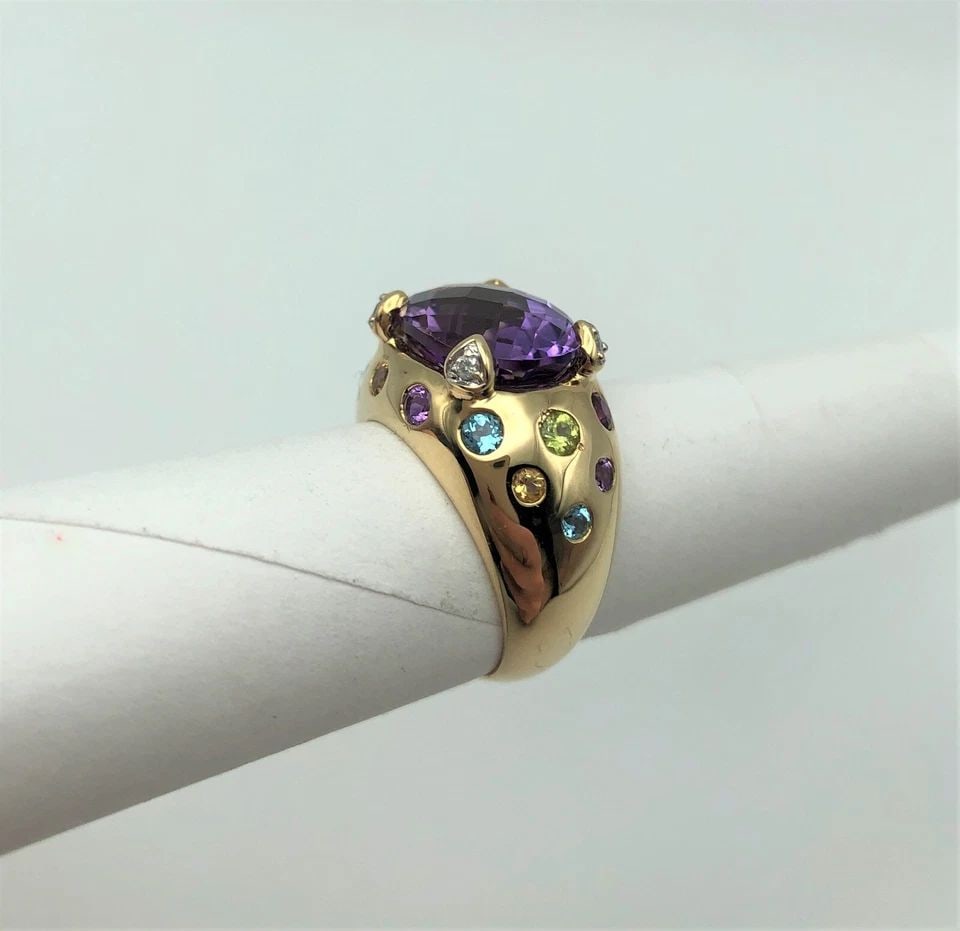 14K GOLD RING CENTER AMETHYST AND MULTI-COLORED STONES SIZE: 6 7.4G: 14K GOLD RING WITH MULTI-STONE RING (SIZE: 6) 14k Gold Ring with Multiple Different types of Colored Stones You are bidding on a 14k Gold Ring with Multiple Different types of Colored Stones. The ring