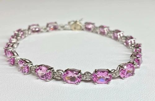 10K WHITE GOLD BRACELET, 0.08CTS OF DIAMONDS AND PINK C.Z. (7 INCH) 8.5 GRAMS: 10k White Gold Bracelet, 0.08cts of Diamonds and Pink C.Z. You are bidding on a pre-owned Women's 10k White Gold Bracelet with Diamonds and Pink Stones. The bracelet has minor scuffs and scratches fro