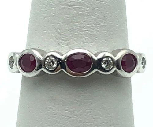 14K WHITE GOLD RING WITH NATURAL RUBIES AND 0.12CTW DIAMONDS (SIZE 7) 4.1 GRAM: 14K WHITE GOLD RING SET WITH NATURAL RUBIES AND 0.12CTS OF DIAMONDS SIZE: 7 14k White Gold Ring set with Natural Rubies and 0.12cts of Diamonds Condition: Used Material: 14k White Gold Ring Size: 7 We
