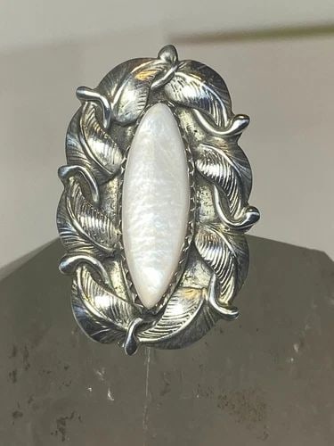 MOTHER OF PEARL RING LONG NAVAJO STERLING SILVER WOMEN GIRLS: MOTHER OF PEARL RING LONG NAVAJO STERLING SILVER WOMEN GIRLS Mother of Pearl ring long Navajo sterling silver women girls Size 4.50 Between a size 4.50 and a size 5 Weight 6.5g Length 1. 1/4" Width 7/