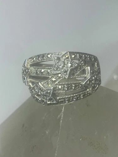 STARS RING MARCASITES CELESTIAL BAND STERLING SILVER WOMEN: STARS RING MARCASITES CELESTIAL BAND STERLING SILVER WOMEN Stars ring marcasites band sterling silver women Size 8 Weight 9.3g Widest part 5/8" Thinnest part of band 3/16" Band Width 1/16"
