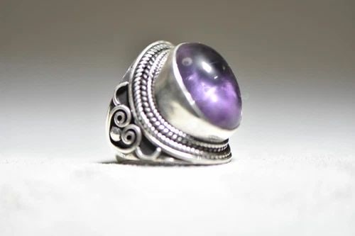 AMETHYST RING STERLING SILVER WOMEN GIRLS: AMETHYST RING STERLING SILVER WOMEN GIRLS Amethyst ring sterling silver women girls Size 7.75 Between a size 7.75 and a size 8 Weight. 19.4g Length of the front 1 1/8" Length of the stone 3/4" Width o