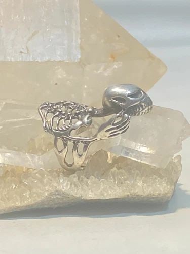 SKULL RING SKELETON BIKER BAND STERLING SILVER WOMEN: SKULL RING SKELETON BIKER BAND STERLING SILVER WOMEN Skull ring skeleton biker band sterling silver women Size 9 AS IS Band Is CUT Weight 11.8g Length. 1. 1/2" Width 3/4" Thinnest part of band 3/16"