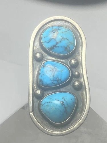 NAVAJO RING LONG TURQUOISE SOUTHWEST STERLING SILVER WOMEN: NAVAJO RING LONG TURQUOISE SOUTHWEST STERLING SILVER WOMEN Navajo Ring long turquoise southwest sterling silver women Size 7.25 Weight 23.8g Length. 2 1/2" Width. 1. 1/4" Thinnest part 1/4"
