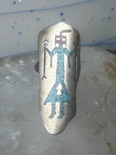 LONG KACHINA RING NAVAJO 6.75 TURQUOISE CORAL CHIP SHIELD STERLING SILVER WOMEN: Long Kachina ring Navajo 6.75 turquoise coral chip shield sterling silver women Between a size 6.75 and a size 7 Weight 6.1g Length. 1 3/8" Width. 3/4" Thinnest part of band 1/8"