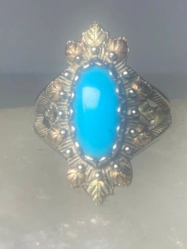 LONG TURQUOISE RING BLACK HILLS GOLD LEAVES STERLING SILVER WOMEN GIRLS: LONG TURQUOISE RING BLACK HILLS GOLD LEAVES STERLING SILVER WOMEN GIRLS Long Turquoise ring Black Hills Gold leaves sterling silver women girls Size 6.75 Weight 5.6g length 1 1/16" Width 5/8" Thinnest