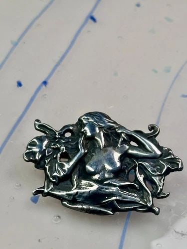 NAKED LADY IN THE FLOWERS LEAVES STERLING SILVER PIN: NAKED LADY IN THE FLOWERS LEAVES STERLING SILVER PIN Naked Lady in the flowers Leaves Sterling Silver Pin Length 1" Width. 1 3/8"