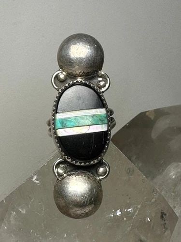 LONG NAVAJO RING ONYX TURQUOISE MOP SIZE 7 STERLING SILVER WOMEN: LONG NAVAJO RING ONYX TURQUOISE MOP SIZE 7 STERLING SILVER WOMEN Long Navajo ring onyx turquoise mop size 7 sterling silver women Size 7 Weight. 9.5g Length 2" Width 5/8" Thinnest pat of band 3/16"