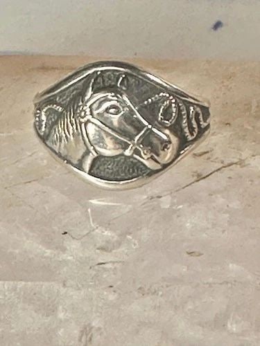 HORSE RING SIZE 6.75 COWGIRL BAND BY BELL STERLING SILVER WOMEN: HORSE RING SIZE 6.75 COWGIRL BAND BY BELL STERLING SILVER WOMEN Horse ring size 6.75 cowgirl band by Bell sterling silver women Size 6.75 Weight 4.4g Width 1/2 " Thinnest part of band.1/8"
