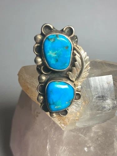 LONG TURQUOISE RING NAVAJO SOUTHWEST STERLING SILVER WOMEN: LONG TURQUOISE RING NAVAJO SOUTHWEST STERLING SILVER WOMEN Long Turquoise ring Navajo southwest sterling silver women Size 8.25 Weight 10.7g Length. 1 1/2" Width 7/8" Thinnest part of the band in back
