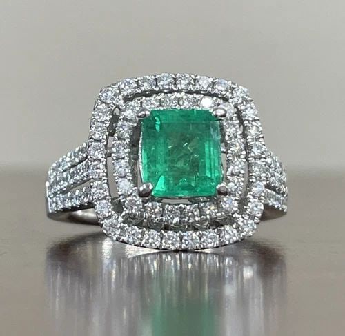 1.26 CARAT COLOMBIAN EMERALD (CERTIFIED) AND DIAMOND RING IN 14K WHITE GOLD: 1.26 CARAT COLOMBIAN EMERALD (CERTIFIED) AND DIAMOND RING IN 14K WHITE GOLD Showcase your love for luxurious jewelry with this stunning 1.26 Carat Colombian Emerald (Certified) and Diamond Ring in 14K