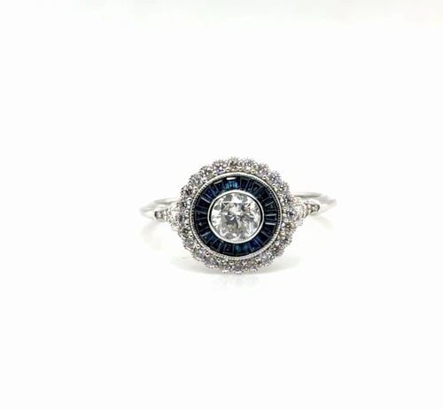.45CT DIAMOND AND BLUE SAPPHIRE RING IN 14 WHITE GOLD: .45CT DIAMOND AND BLUE SAPPHIRE RING IN 14 WHITE GOLD Elevate your look with this stunning Unisex ring crafted in 14K white gold Featuring a captivating round cut diamond weighing 43ct F vvs2 as the c
