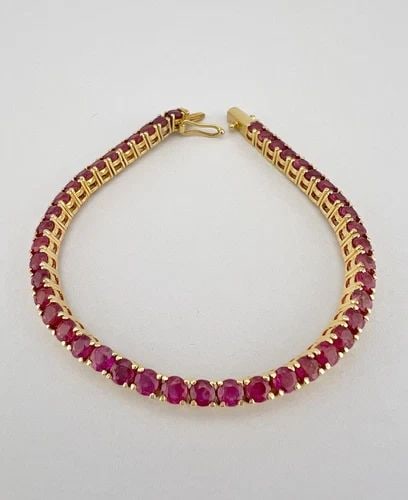 DESIGNER 12K YELLOW GOLD 6.75CT ROUND CUT RUBY INFINITY TENNIS BRACELET 6.25": DESIGNER 12K YELLOW GOLD 6.75CT ROUND CUT RUBY INFINITY TENNIS BRACELET 6.25" Designer 12k Yellow Gold 6.75ct Round Cut Ruby Infinity Tennis Bracelet 6.25" Size: 6.25" Long By (3mm) Wide Metal: Hallma