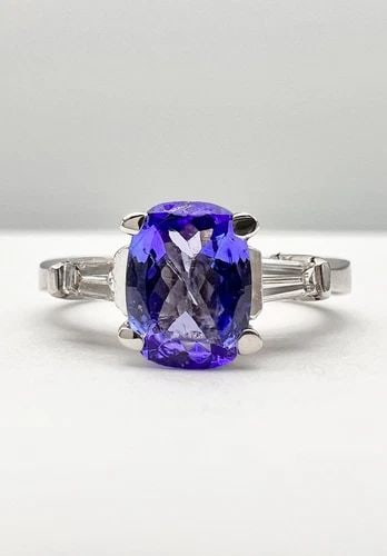 DESIGNER 18K WHITE GOLD NATURAL OVAL CUSHION TANZANITE & BAGUETTE DIAMOND RING: DESIGNER 18K WHITE GOLD NATURAL OVAL CUSHION TANZANITE & BAGUETTE DIAMOND RING Designer 18k White Gold Natural Oval Cushion Tanzanite & Baguette Diamond Ring Size: 7.75 - Can Be Resized Weight is 6.8 