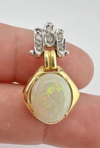 FINE DESIGNER 18K YELLOW & WHITE GOLD AUSTRALIAN FIRE OPAL & DIAMOND PENDANT: FINE DESIGNER 18K YELLOW & WHITE GOLD AUSTRALIAN FIRE OPAL & DIAMOND PENDANT Fine Designer 18k Yellow & White Gold Australian Fire Opal & Diamond Pendant Size: 1 1/8" Tall by 5/8" Wide At The Base Wei