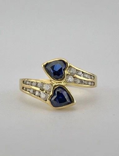 DESIGNER 18K YELLOW GOLD HEART SHAPED BLUE SAPPHIRE & DIAMOND BYPASS RING: DESIGNER 18K YELLOW GOLD HEART SHAPED BLUE SAPPHIRE & DIAMOND BYPASS RING Designer 18K Yellow Gold Heart Shaped Blue Sapphire & Diamond Bypass Ring Ring Size: 6.75 - Can be Resized With Out Damage Wei