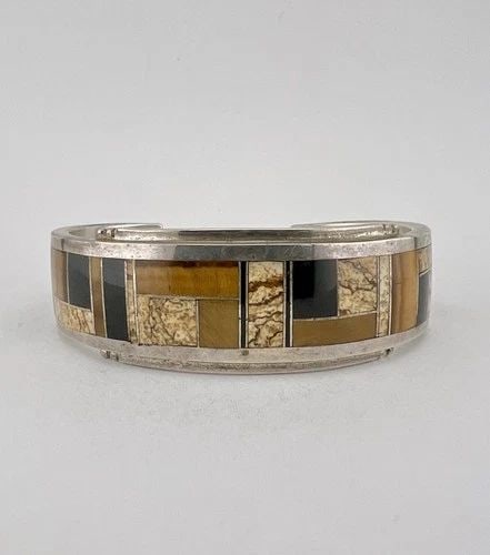 DONNY & DOROTHY CLARK STERLING SILVER MULTI GEMSTONE FLUSH INLAY CUFF BRACELET: DONNY & DOROTHY CLARK STERLING SILVER MULTI GEMSTONE FLUSH INLAY CUFF BRACELET Vtg Donny & Dorothy Clark Sterling Silver Multi Gemstone Flush Inlay Cuff Bracelet Cuff is 5 1/2" tip to Tip and has a 1 