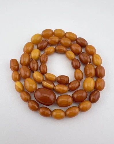 21.5G- ANTIQUE BUTTERSCOTCH EGG YOLK BALTIC AMBER SWIRL OVAL BEAD NECKLACE 21.5": 21.5G- ANTIQUE BUTTERSCOTCH EGG YOLK BALTIC AMBER SWIRL OVAL BEAD NECKLACE 21.5" 21.5g- Antique Butterscotch Egg Yolk Baltic Amber Swirl Oval Bead Necklace 21.5" Necklace Size: 21.5" Long Weight is 21