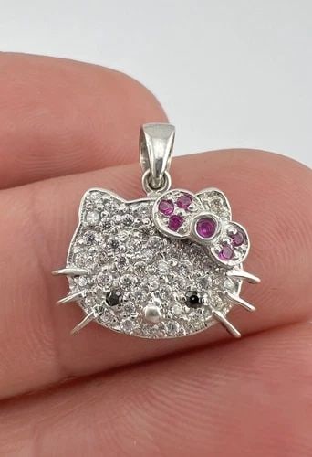 KIMORA LEE SIMMONS HELLO KITTY 18K WHITE GOLD CUBIC-ZIRCONIA PENDANT: KIMORA LEE SIMMONS HELLO KITTY 18K WHITE GOLD CUBIC-ZIRCONIA PENDANT Kimora Lee Simmons HELLO KITTY 18k White Gold & Pave Cubic-Zirconia Pendant Size: 3/4" Tall With Bail by 5/8" Wide Metal: 18k White