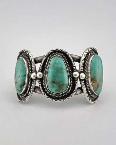 VINTAGE NAVAJO STERLING SILVER PILOT MOUNTAIN TURQUOISE STAMPED CUFF BRACELET: Vintage Navajo Sterling Silver Pilot Mountain Turquoise Stamped Cuff Bracelet Cuff is Just Under 4 3/4" tip to Tip and has a 1 1/8" Wide Adjustable Gap Cuff Is 1 1/4" Wide In the Center Weight is 43.2