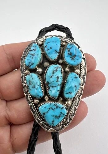 VTG NAVAJO STERLING SILVER SLEEPING BEAUTY TURQUOISE CLUSTER STAMPED BOLO TIE: VTG NAVAJO STERLING SILVER SLEEPING BEAUTY TURQUOISE CLUSTER STAMPED BOLO TIE Vtg Navajo Sterling Silver Sleeping Beauty Turquoise Cluster Stamped Bolo Tie Size: 2 1/2" Tall by 1 3/4" Wide Weight is 4