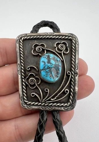 VTG NAVAJO STERLING SILVER SLEEPING BEAUTY TURQUOISE STAMPED FLOWERS BOLO TIE: VTG NAVAJO STERLING SILVER SLEEPING BEAUTY TURQUOISE STAMPED FLOWERS BOLO TIE Vtg Navajo Sterling Silver Sleeping Beauty Turquoise Stamped Flowers Bolo Tie Size: 2 1/8" Tall by 1 3/4" Wide Weight is 4