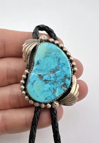 VTG NAVAJO STERLING SILVER HIGH-GRADE SLEEPING BEAUTY TURQUOISE STAMPED BOLO TIE: VTG NAVAJO STERLING SILVER HIGH-GRADE SLEEPING BEAUTY TURQUOISE STAMPED BOLO TIE Vtg Navajo Sterling Silver High-Grade Sleeping Beauty Turquoise Stamped Bolo Tie Size: 1 3/4" Tall by 1 3/8" Wide Weigh
