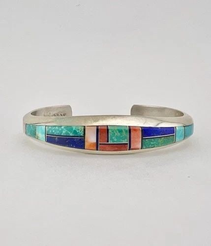 VTG PHILLIP SANCHEZ NAVAJO STERLING SILVER MULTI GEMSTONE FLUSH CUFF BRACELET #2: VTG PHILLIP SANCHEZ NAVAJO STERLING SILVER MULTI GEMSTONE FLUSH CUFF BRACELET #2 Vtg Phillip Sanchez Navajo Sterling Silver Multi Gemstone Flush Cuff Bracelet #2 Cuff is 5 1/2" tip to Tip and has a 1 