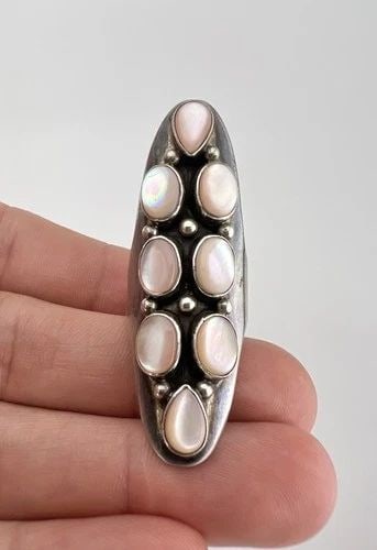 HUGE VTG NAVAJO STERLING SILVER PINK MOTHER OF PEARL CLUSTER LONG RING - 2 1/8": HUGE Vtg Navajo Sterling Silver Pink Mother Of Pearl Cluster Long Ring - 2 1/8" Ring Size: 7.25 - Can Be Re Sized Weight is 13.5 Grams on my scale Metal: Sterling Silver Ring is 2 1/8" Tall In the Cen