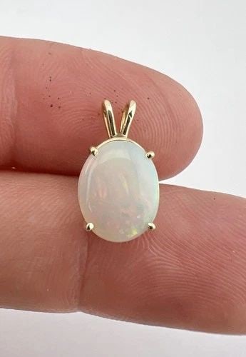 DESIGNER 14K YELLOW GOLD NATURAL AUSTRALIAN OVAL FIRE OPAL PENDANT: DESIGNER 14K YELLOW GOLD NATURAL AUSTRALIAN OVAL FIRE OPAL PENDANT Designer 14k Yellow Gold Natural Australian Oval Fire Opal Pendant Size: 5/8" Tall with Bail by 3/8" Wide Weight is 1.0 Grams on My S