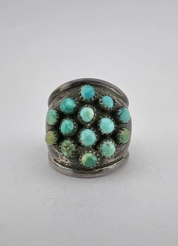 EARLY 1950'S NAVAJO INGOT SILVER & SNAKE EYE'S TURQUOISE CLUSTER WOMEN'S RING: EARLY 1950's NAVAJO INGOT SILVER & SNAKE EYE'S TURQUOISE CLUSTER WOMEN'S RING Ring Size: 4.5 - Can Be Resized Weight is 5.0 Grams on my scale Test Positive For At Least Coin Silver Ring is 3/4" Tall I