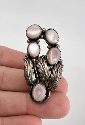 HUGE VTG NAVAJO STERLING SILVER PINK MOTHER OF PEARL CLUSTER STAMPED RING 2": HUGE Vtg Navajo Sterling Silver Pink Mother Of Pearl Cluster Stamped Ring 2" Ring Size: 8.5 - Can Be Re Sized Weight is 11.5 Grams on my scale Metal: Sterling Silver Ring is 2" Tall In the Center Amaz