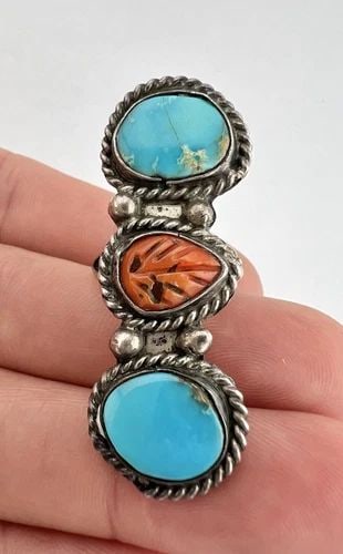 VTG NAVAJO STERLING SILVER TURQUOISE & CARVED CORAL STAMPED LONG RING 1 7/8": VTG NAVAJO STERLING SILVER TURQUOISE & CARVED CORAL STAMPED LONG RING 1 7/8" Vtg Navajo Sterling Silver Turquoise & Carved Coral Stamped Long Ring 1 7/8" Size: 6.5- Can Be Re Sized Weight is 8.8 Grams