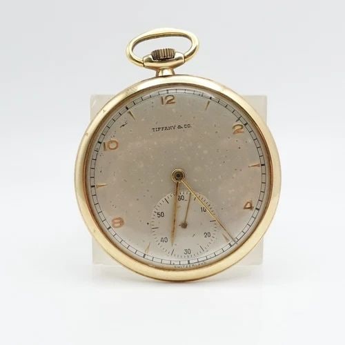 TIFFANY & CO. 14K YELLOW GOLD OPEN FACE MANUAL POCKET WATCH - 45482: Vintage Tiffany & Co. 14K Yellow Gold Movado Movement Open Face Pocket Ref - 45482 Serial Number - 550137 Manual Watch 43mm Wide Height - 2.1" Width - 1.8"