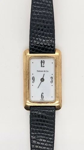 TIFFANY & CO. 14K YELLOW GOLD TANK WATCH - 18MM X 30MM: Tiffany & Co. 14K Yellow Gold Tank Watch with Hirsch after market lizard leather strap Case Size - 18mm x 30mm Total Length - 8.5" Long Great Condition & Keeps Accurate Time New Battery Installed 8/10