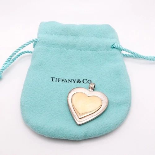 TIFFANY & CO. STERLING SILVER 18K YELLOW GOLD TRIM HEART PENDANT: Tiffany & Co. Sterling Silver 18K Yellow Gold Trim Heart Pendant ONLY Height - 31mm Width - 26mm Pouch NOT Included