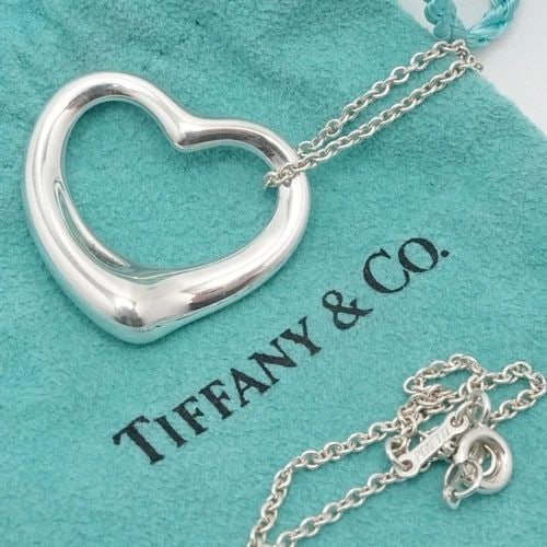 TIFFANY & CO. PERETTI STERLING SILVER 27MM OPEN HEART PENDANT NECKLACE 18" POUCH: Tiffany & Co. Elsa Peretti Sterling Silver Open Heart Medium Pendant Necklace Length - 18" Long Chain Width - 1.5mm Pendant Width - 27mm Est. Retail Price - $700 USD + Tax Total Weight - 10 Grams Hall