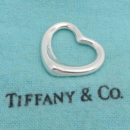 TIFFANY & CO. PERETTI STERLING SILVER OPEN HEART PENDANT 22MM ONLY WITH POUCH: TIFFANY & CO. PERETTI STERLING SILVER OPEN HEART PENDANT 22MM ONLY WITH POUCH Tiffany & Co. Elsa Peretti Sterling Silver Open Heart Pendant ONLY Width - 22mm Length - 19mm Total Weight - 3.6 Grams Ver
