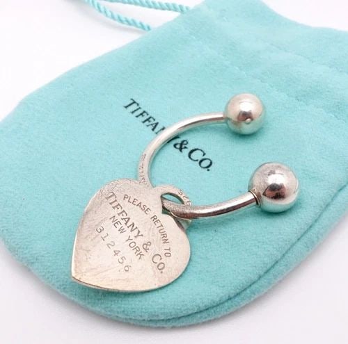 TIFFANY & CO. RETURN TO STERLING SILVER KEY CHAIN HEART TAG CHARM: Tiffany & Co. Sterling Silver Return To Tiffany Heart Tag Screwball Key Tag Height - 1" in. approx. Tag Width - 3/4" in. approx. Est. Retail 250 Pouch NOT Included
