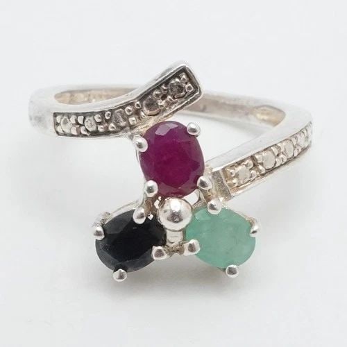 STERLING SILVER OVAL FACETED EMERALD RUBY SAPPHIRE THREE STONE BYPASS RING 8.25: STERLING SILVER OVAL FACETED EMERALD RUBY SAPPHIRE THREE STONE BYPASS RING 8.25 Sterling Silver Oval Faceted Emerald, Ruby, and Sapphire 3 Gemstone Bypass Cocktail Ring Size - 8.25 Band Width - 2.5mm 