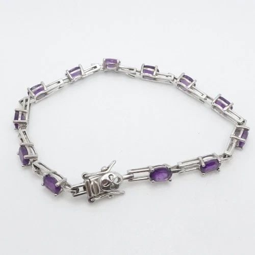 STERLING SILVER OVAL FACETED AMETHYST TENNIS BRACELET 7" LONG: STERLING SILVER OVAL FACETED AMETHYST TENNIS BRACELET 7" LONG Sterling Silver Oval Faceted Amethyst Tennis Bracelet Length - 7" Long Wrist Size - 6.75" Chain Width - 4.5mm Total Weight - 7.3 Grams **O