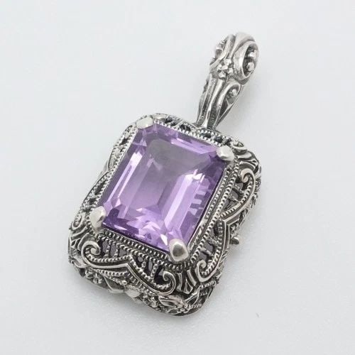STERLING SILVER FILIGREE EMERALD CUT AMETHYST SMALL PENDANT 1": STERLING SILVER FILIGREE EMERALD CUT AMETHYST SMALL PENDANT 1" Sterling Silver Filigree Style Emerald Cut Amethyst Small Pendant Length - 1" Width - 14mm Bail Height - 5mm Bail With - 2mm Gemstone Siz