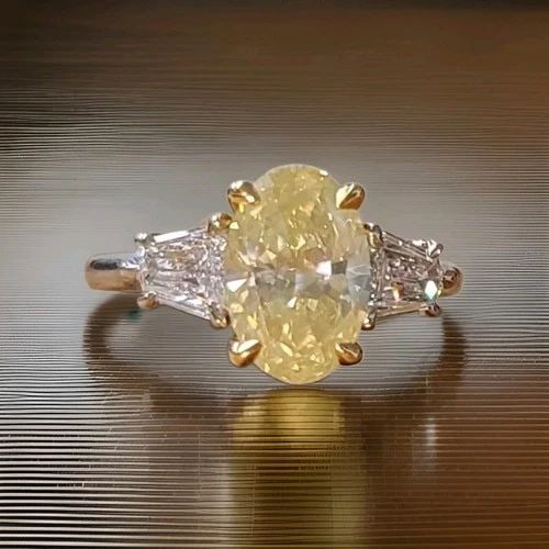 VINTAGE 14K TWO-TONE GOLD ENGAGEMENT RING 2.14CT NATURAL OVAL YELLOW DIAMOND: VINTAGE 14K TWO-TONE GOLD ENGAGEMENT RING 2.14CT NATURAL OVAL YELLOW DIAMOND This stunning vintage engagement ring is a true beauty. Crafted with 14k white and yellow gold and boasting a fancy yellow 