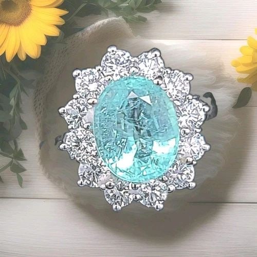 VINTAGE 18K WHITE GOLD ENGAGEMENT RING 3.04CT.NATURAL PARA?BA OVAL CUT GIA CERT: VINTAGE 18K WHITE GOLD ENGAGEMENT RING 3.04CT.NATURAL PARA?BA OVAL CUT GIA CERT This exceptional vintage 18K white gold engagement ring showcases a breathtaking natural oval-cut Paraiba tourmaline wei