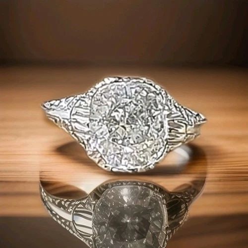 18K WHITE GOLD VINTAGE FILIGREE ENGAGEMENT RING 2.64CT. NATURAL CUSHION DIAMOND: 18K WHITE GOLD VINTAGE FILIGREE ENGAGEMENT RING 2.64CT. NATURAL CUSHION DIAMOND An exceptional Art Deco-era engagement ring, crafted in 18K white gold, showcasing timeless elegance and intricate vinta