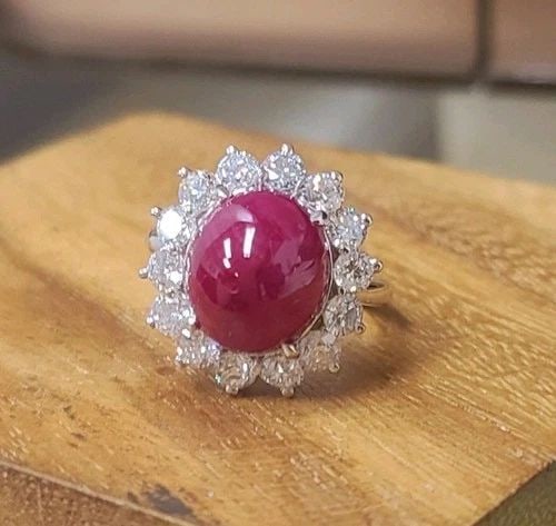 14K WHITE GOLD ENGAGEMENT RING 10.82CT.NATURAL RUBY CABOCHON SHAPE DIAMONDS: 14K WHITE GOLD ENGAGEMENT RING 10.82CT.NATURAL RUBY CABOCHON SHAPE DIAMONDS Make a bold statement with this exceptional 14K white gold engagement ring, showcasing a magnificent natural oval cabochon r